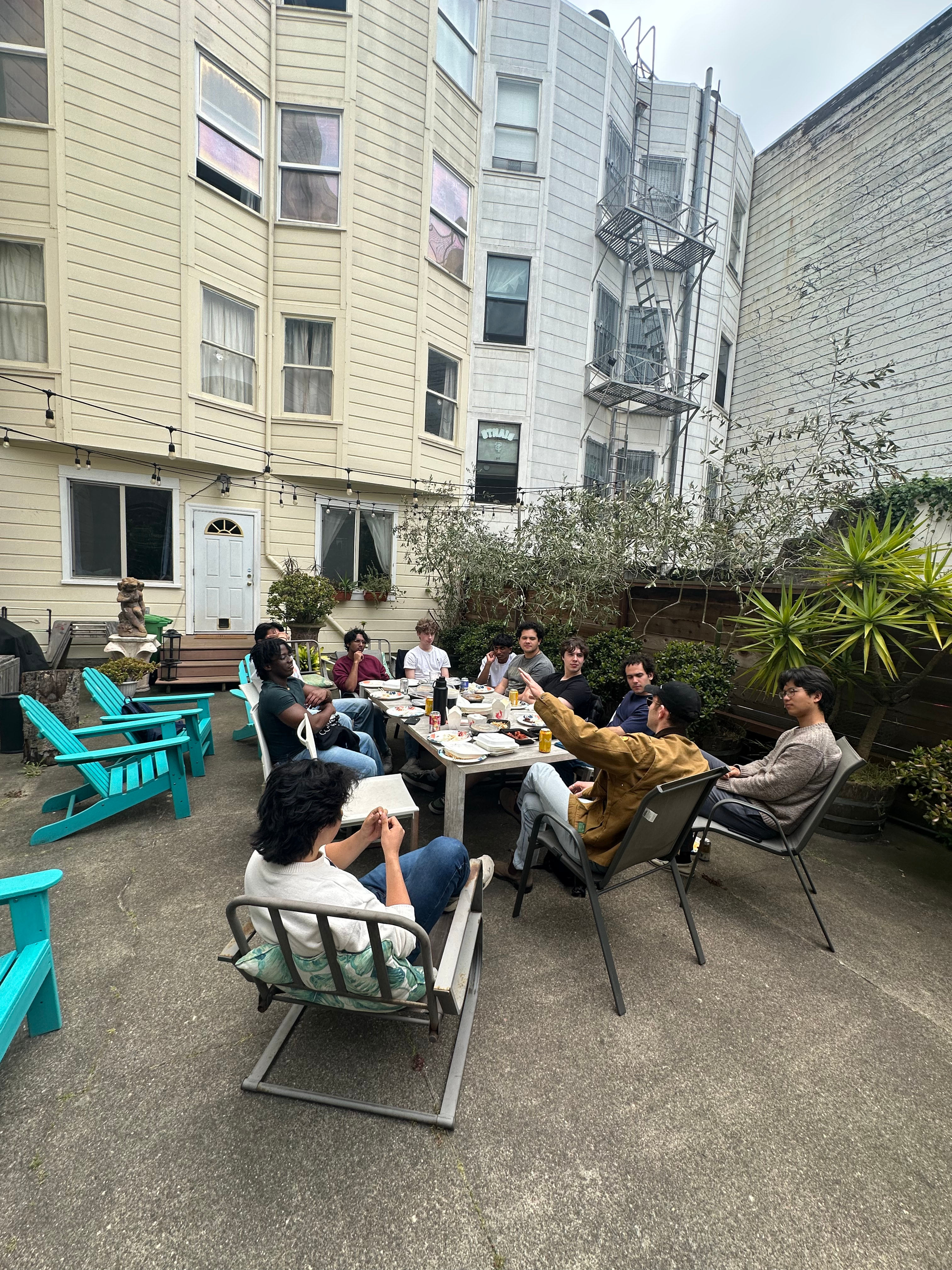 Jake Saper talking with residents in the backyard