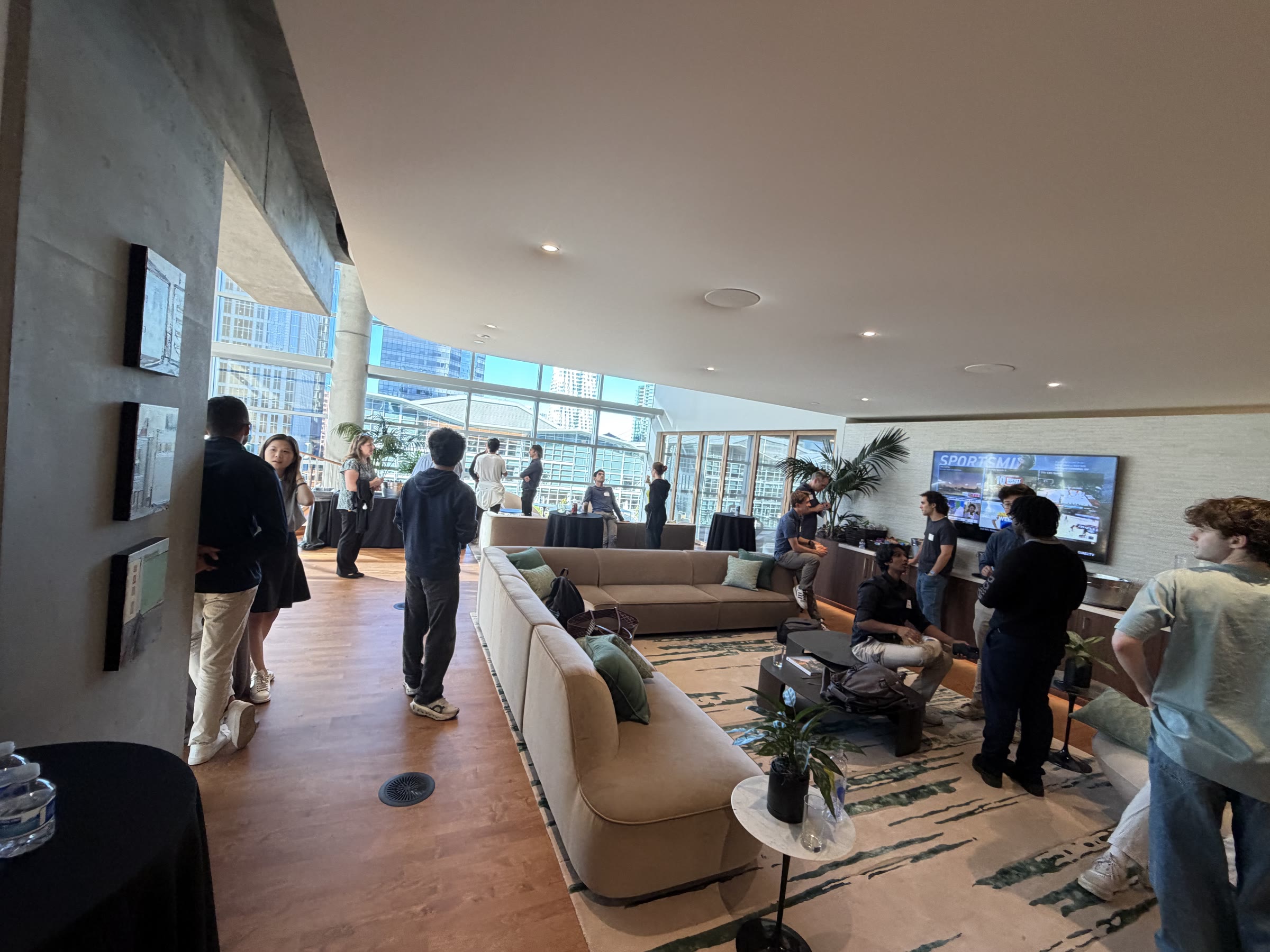 Residents and guests in conversation around the lounge sofas